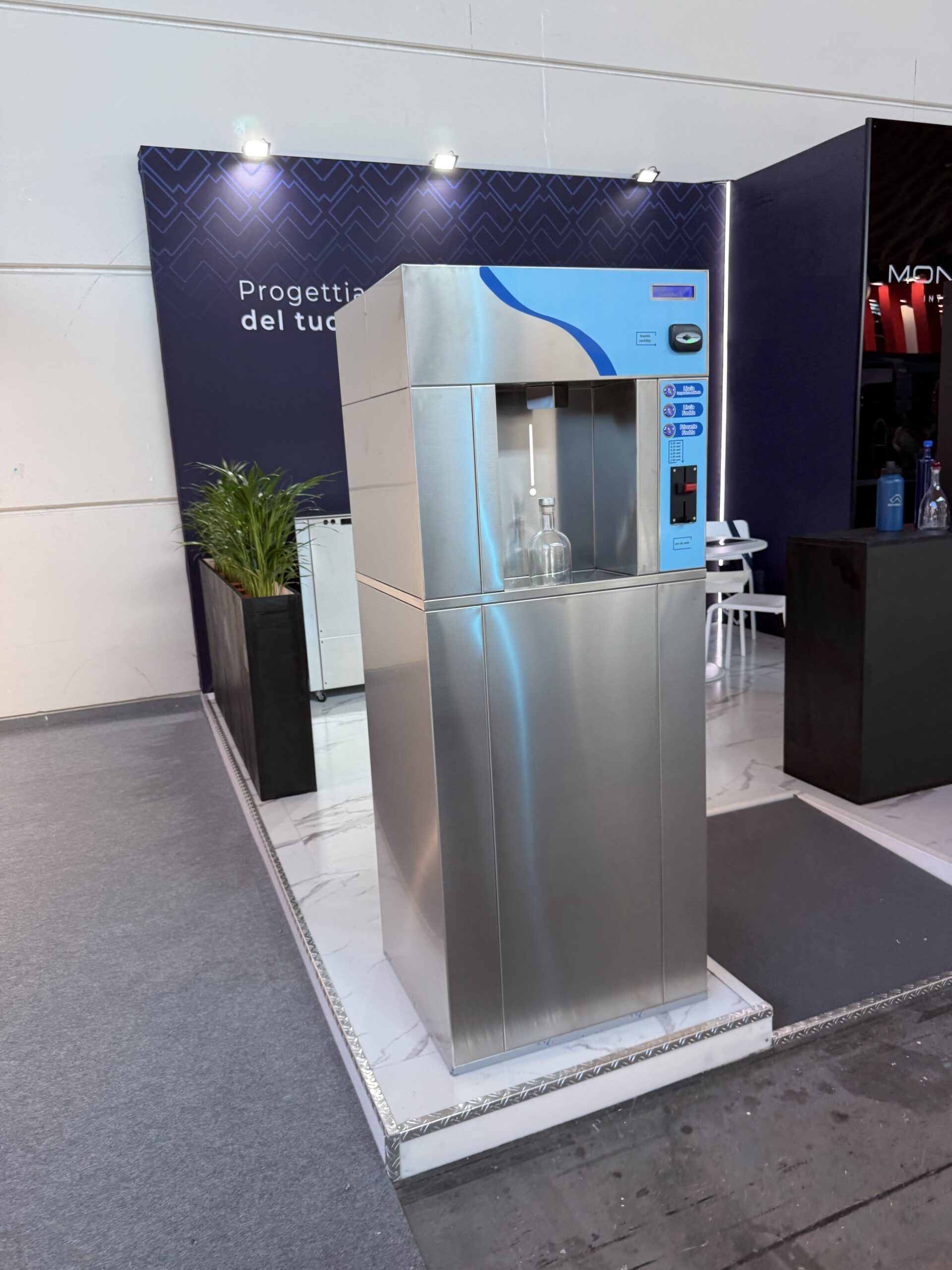 Stainless steel water refill machine dispensing filtered water into a bottle