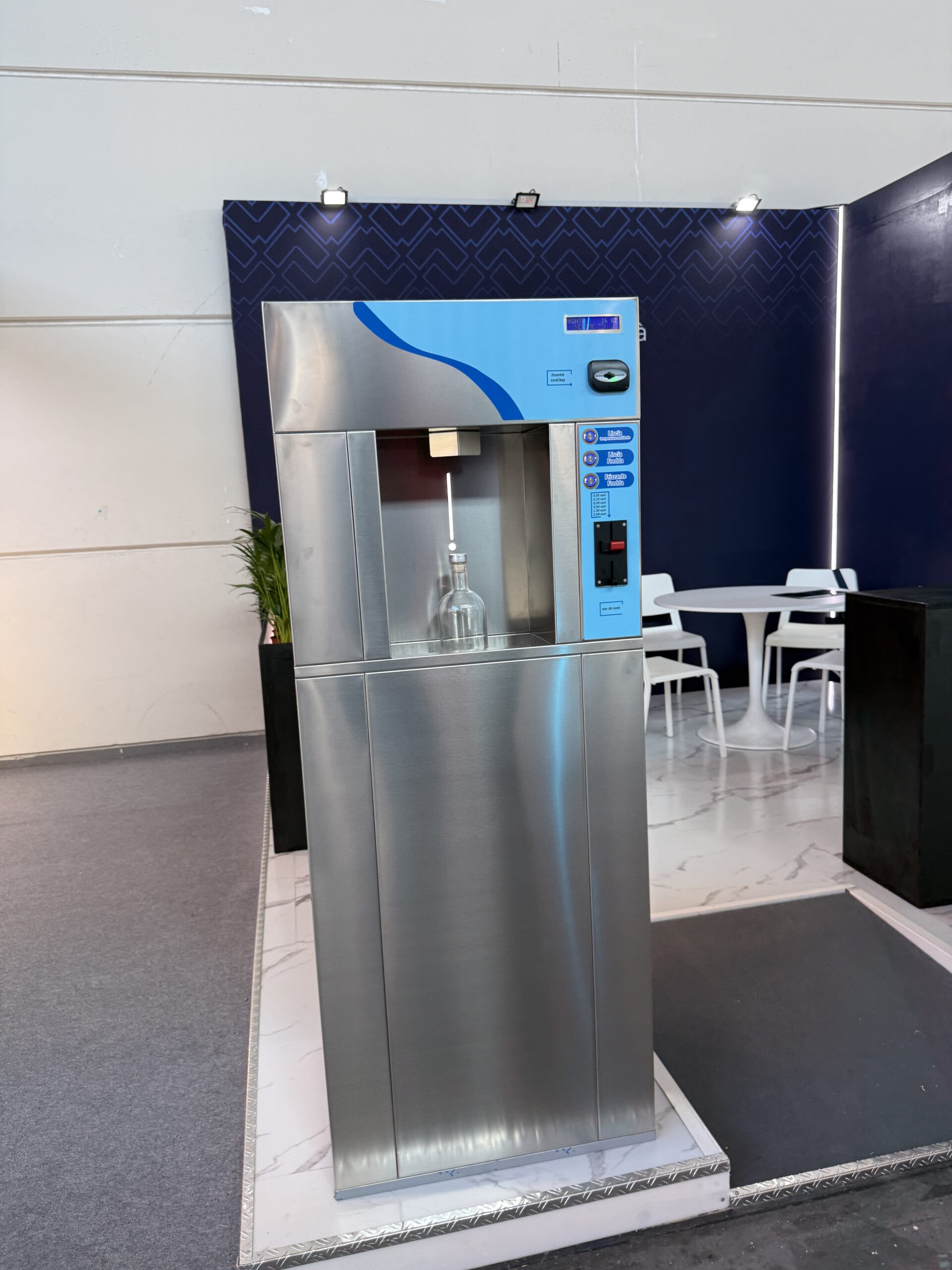 Water refill machine panel showing chilled still, sparkling and ambient water options