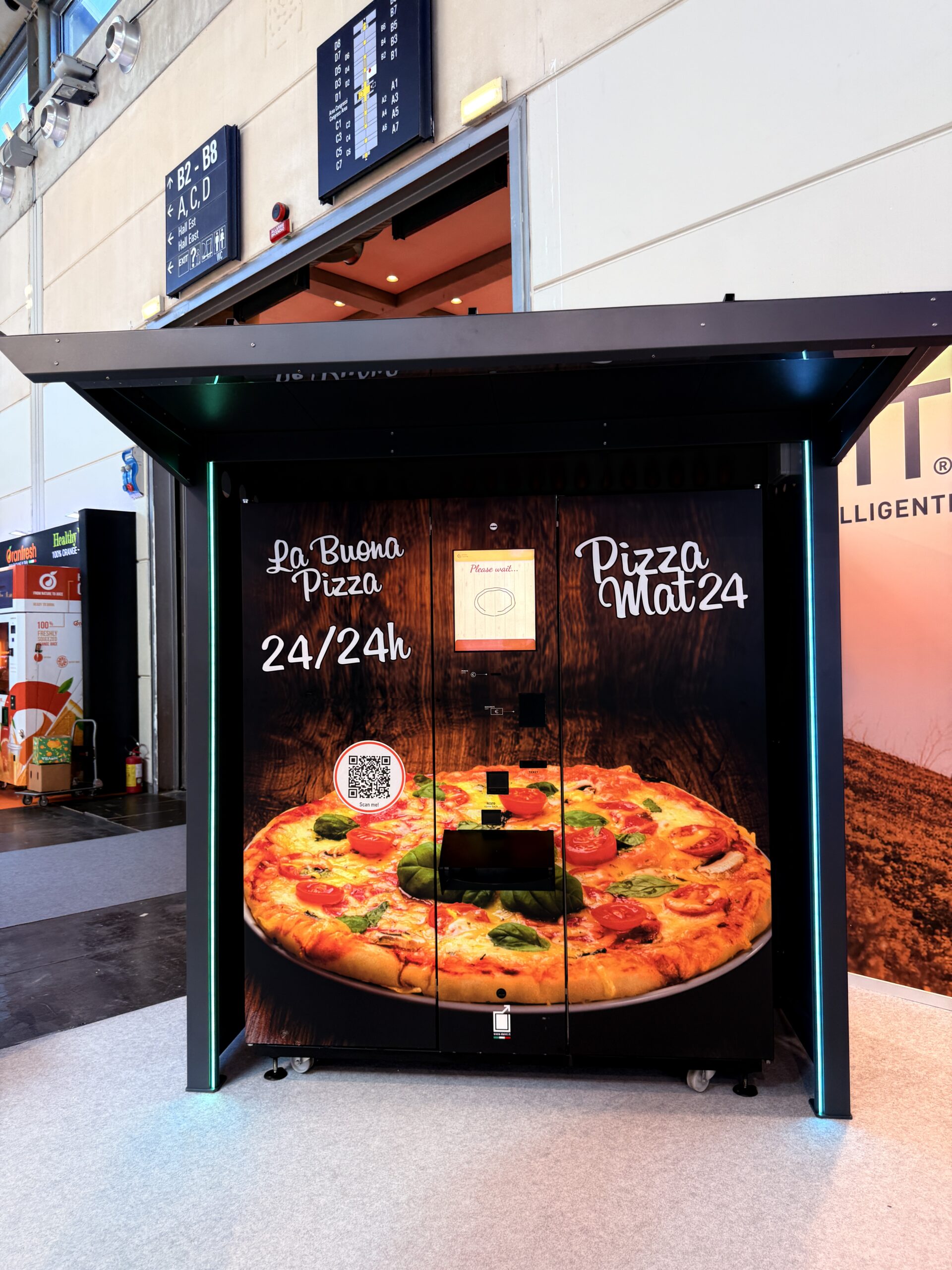 Outdoor pizza vending machine lit at night